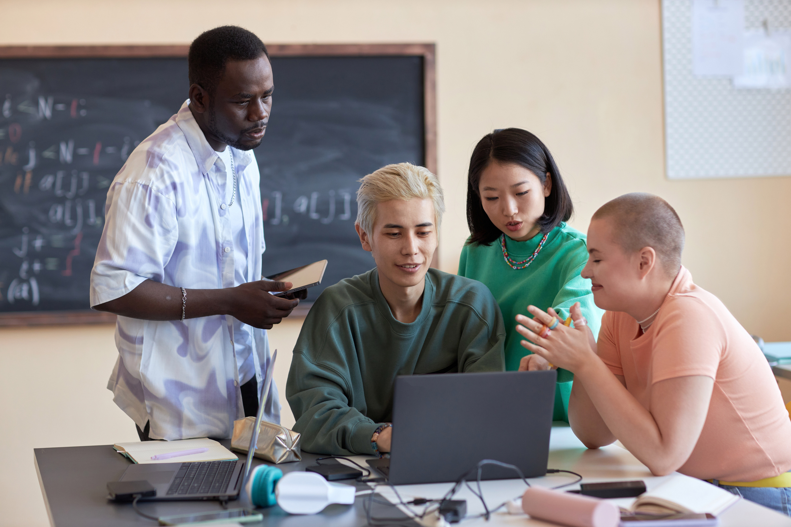 Group of Young Intercultural Students or IT Engineers Discussing Online Data